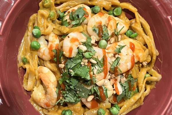 Curried pumpkin peanut shrimp noodles with peas, cilantro and sriracha