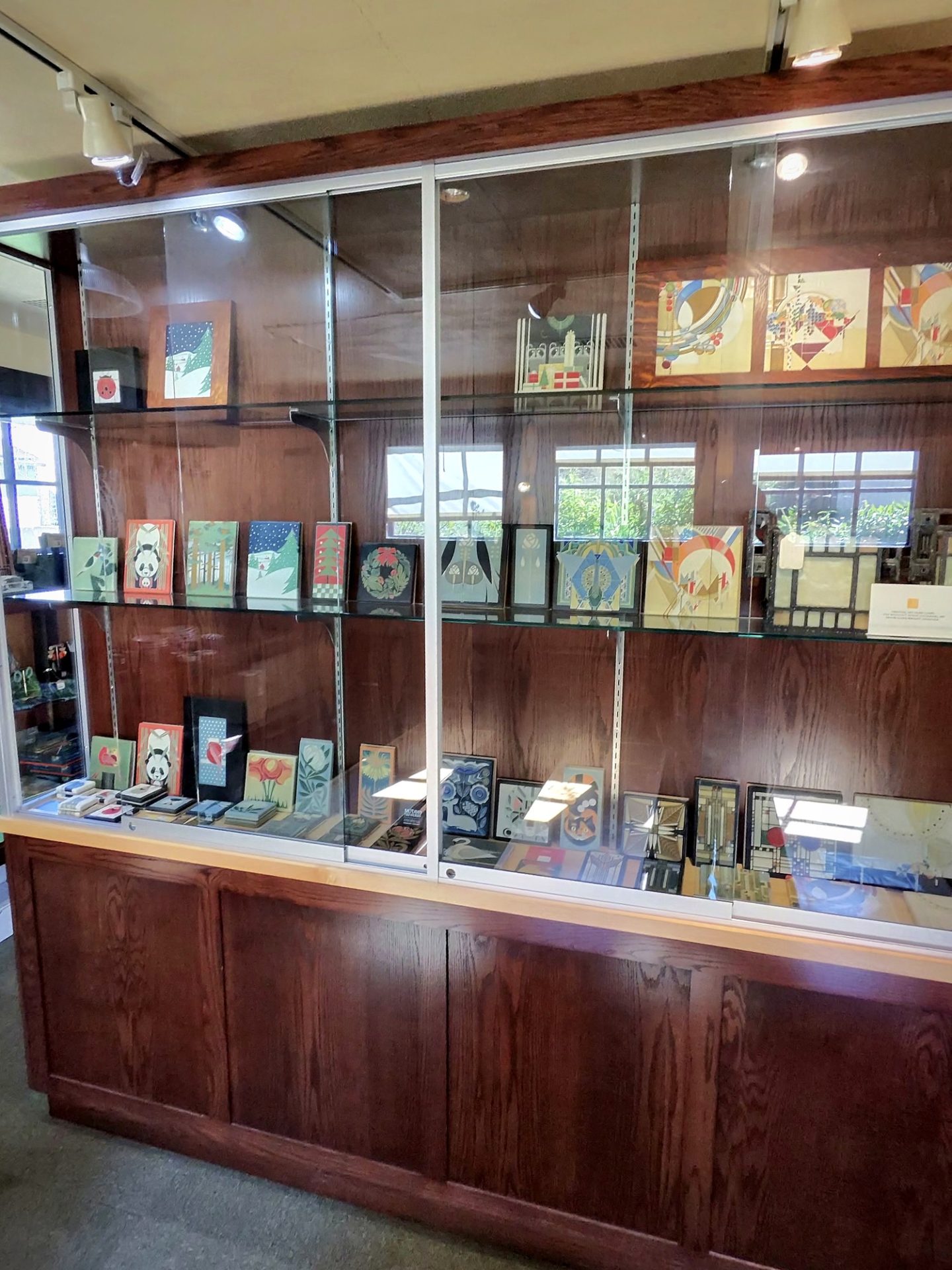 Glass display case of Frank Lloyd Wright design cards and geometric art prints at Westcott House gift shop