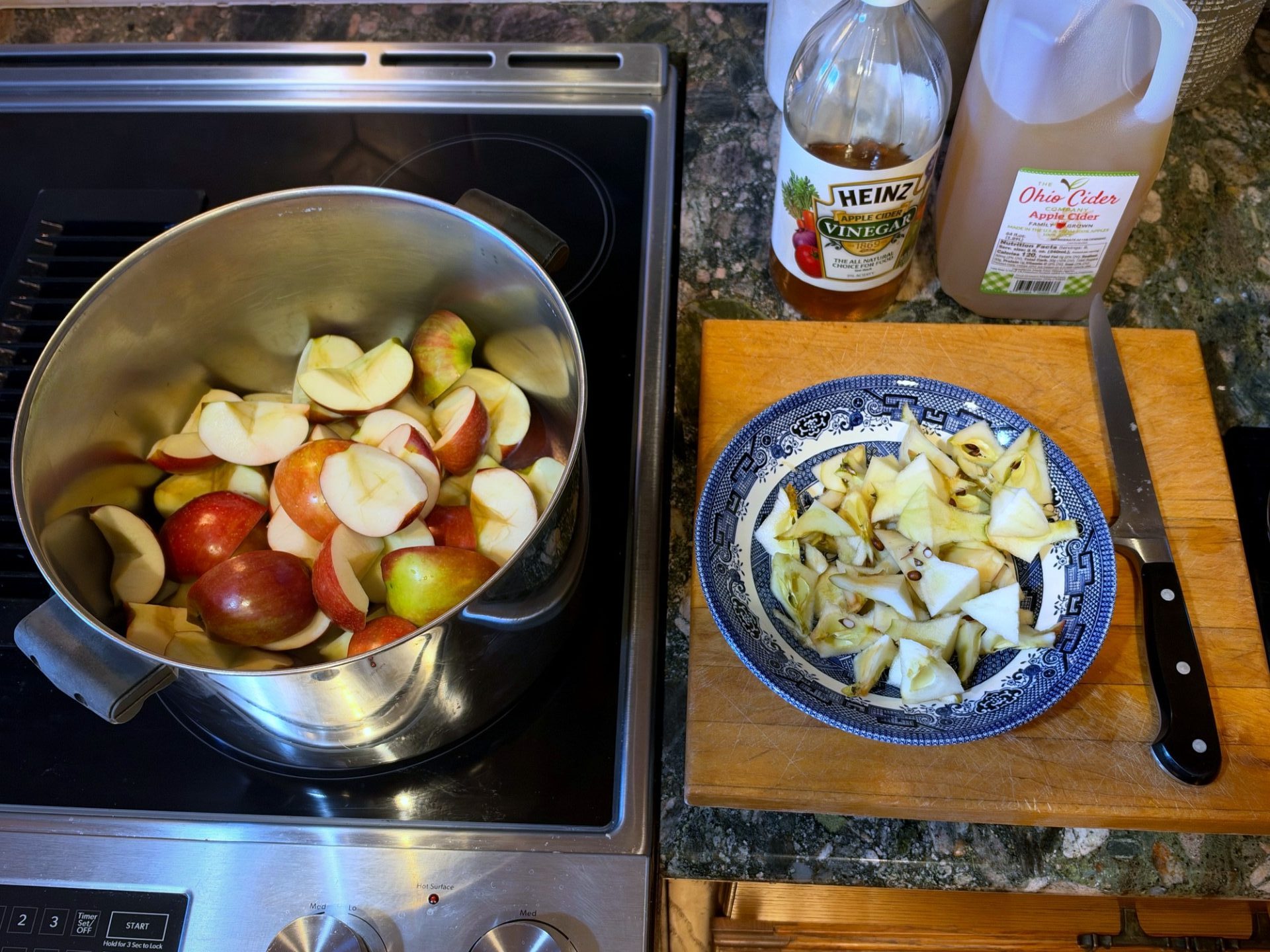 Quartered and cored apples going into the pot