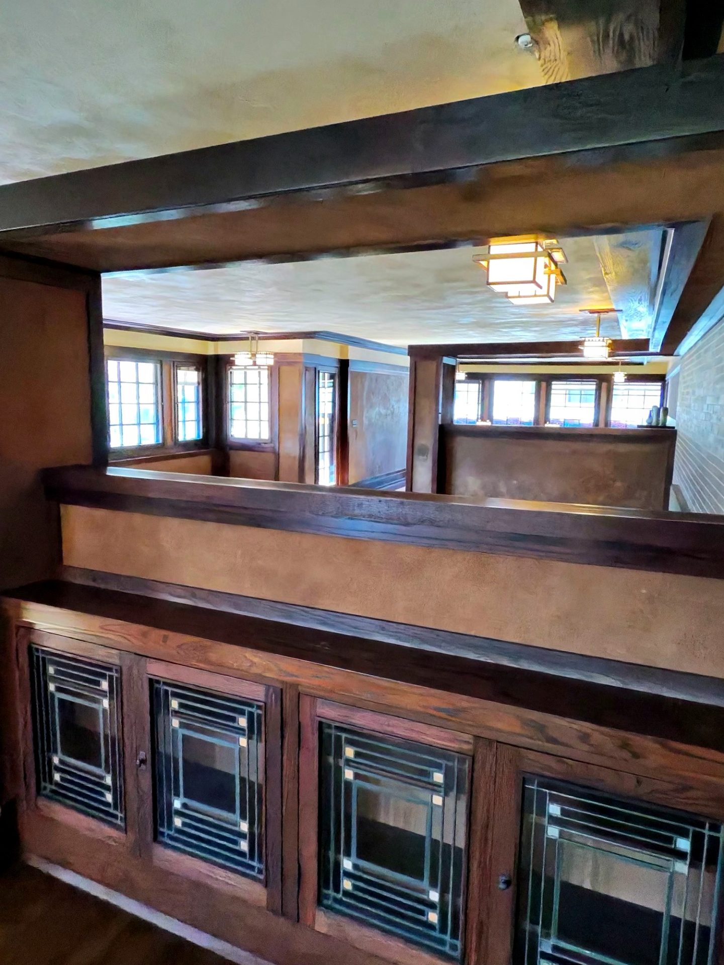 Leaded-glass built-in cabinets and view through wood framing into Westcott House living spaces