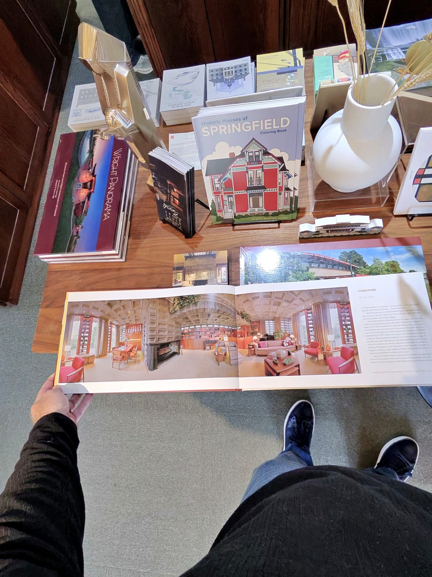 Open Wright Panorama coffee-table book showing a Frank Lloyd Wright interior spread on the gift shop table