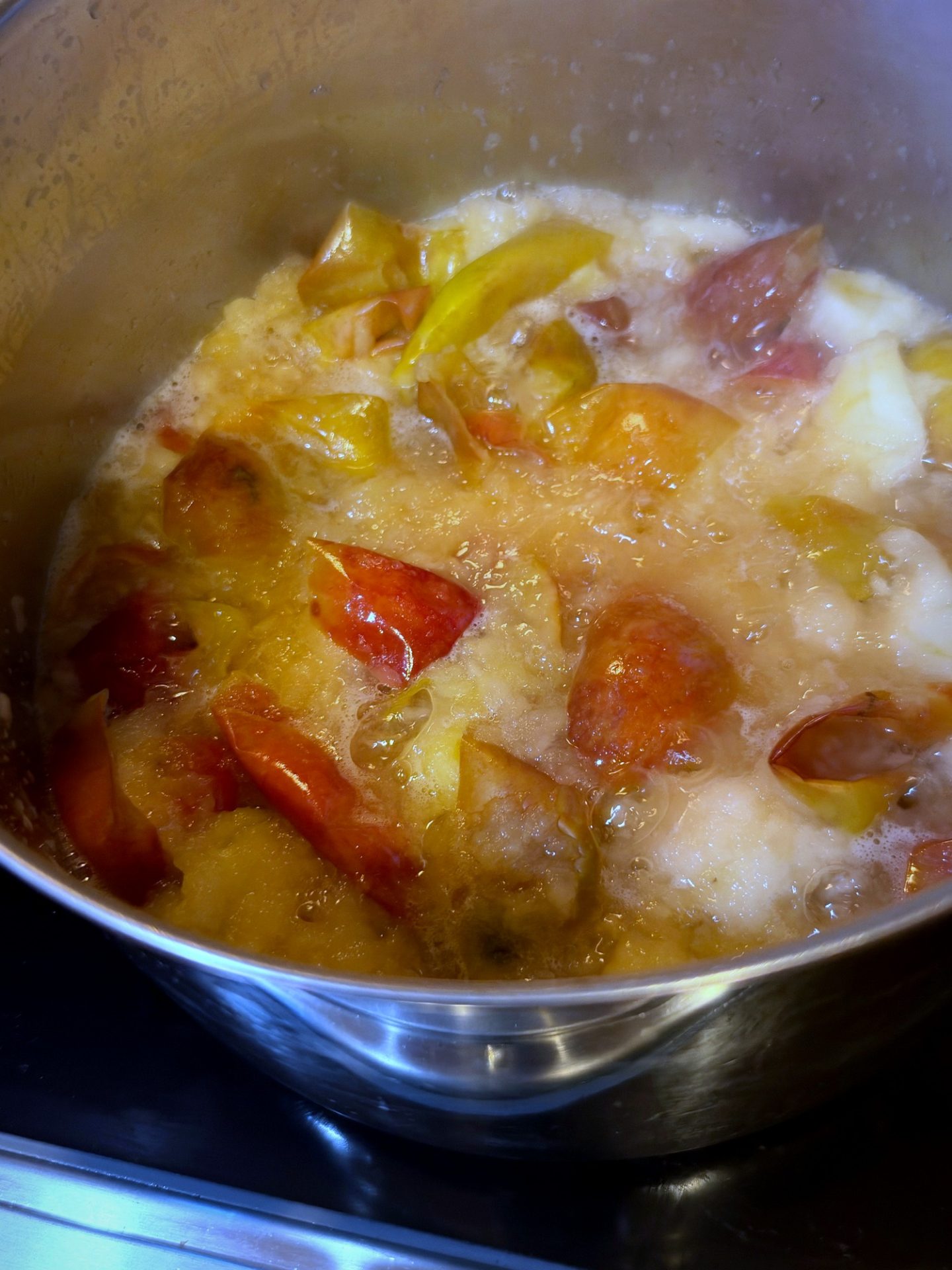 Apple quarters simmering in cider and vinegar