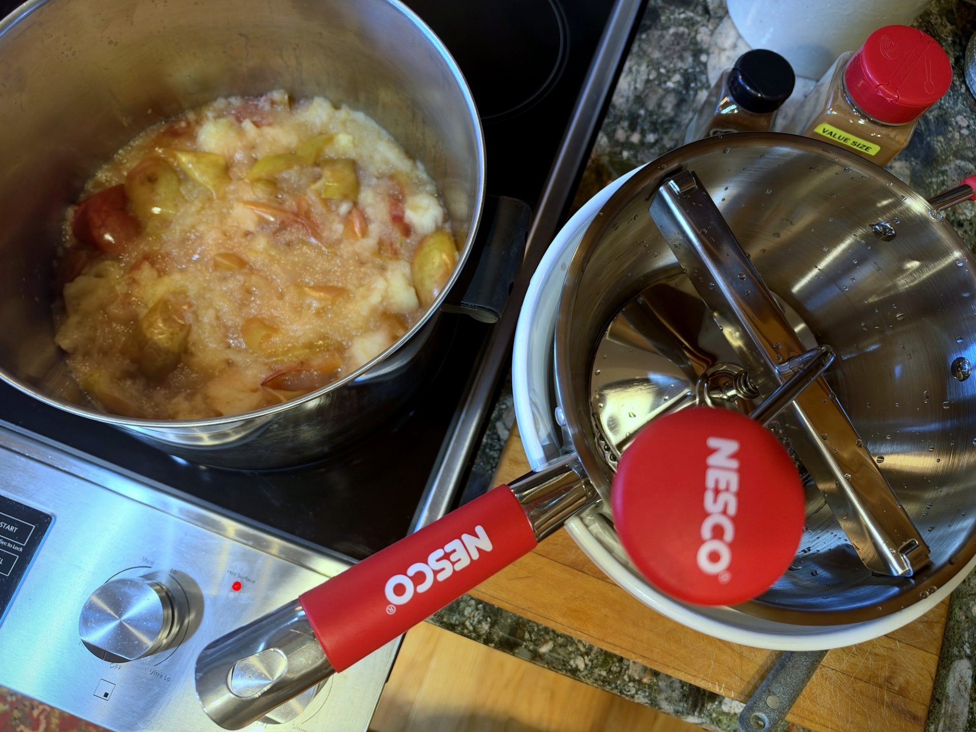 Soft cooked apples beside the food mill