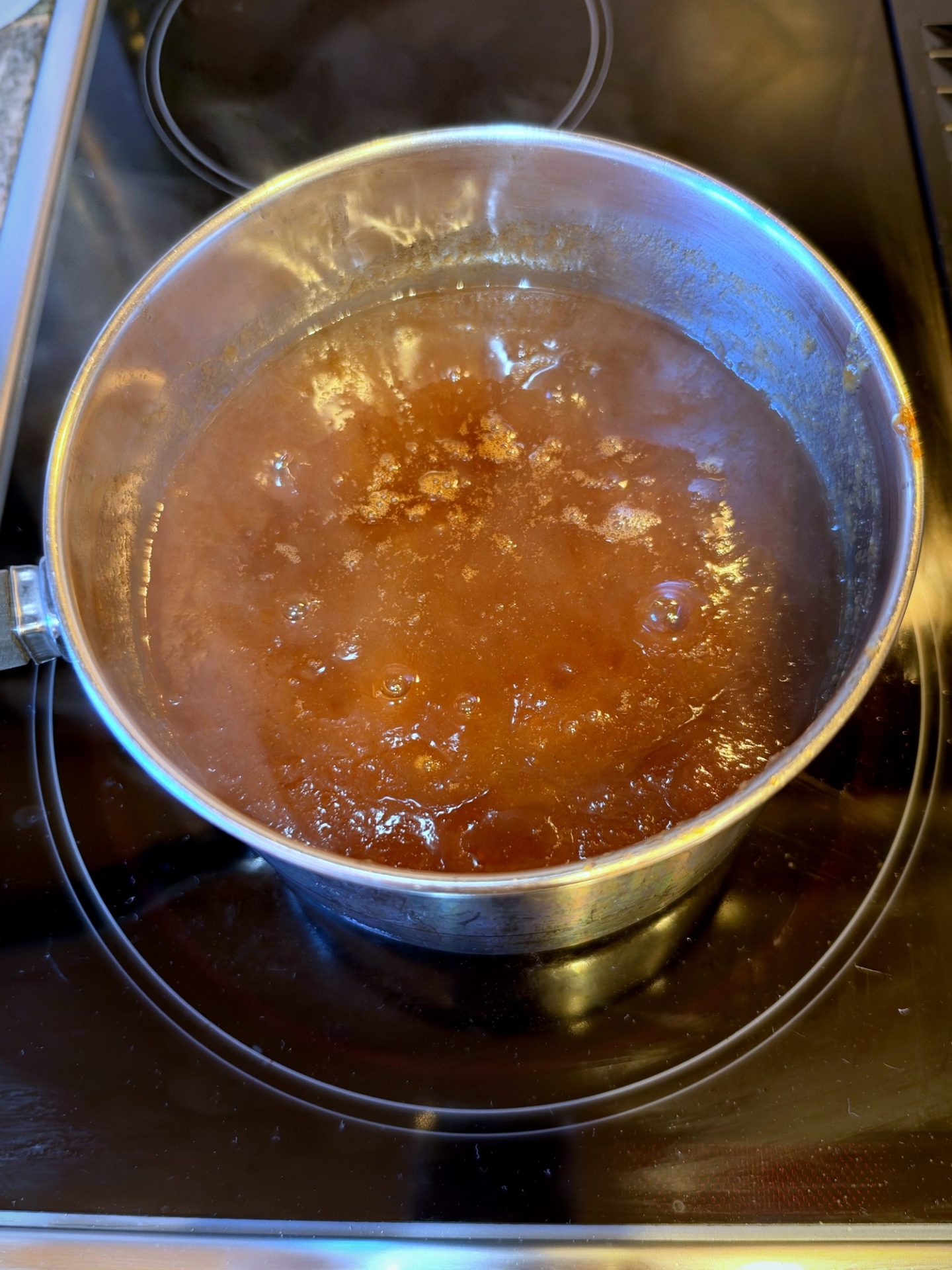 Apple butter cooking down in a heavy pot