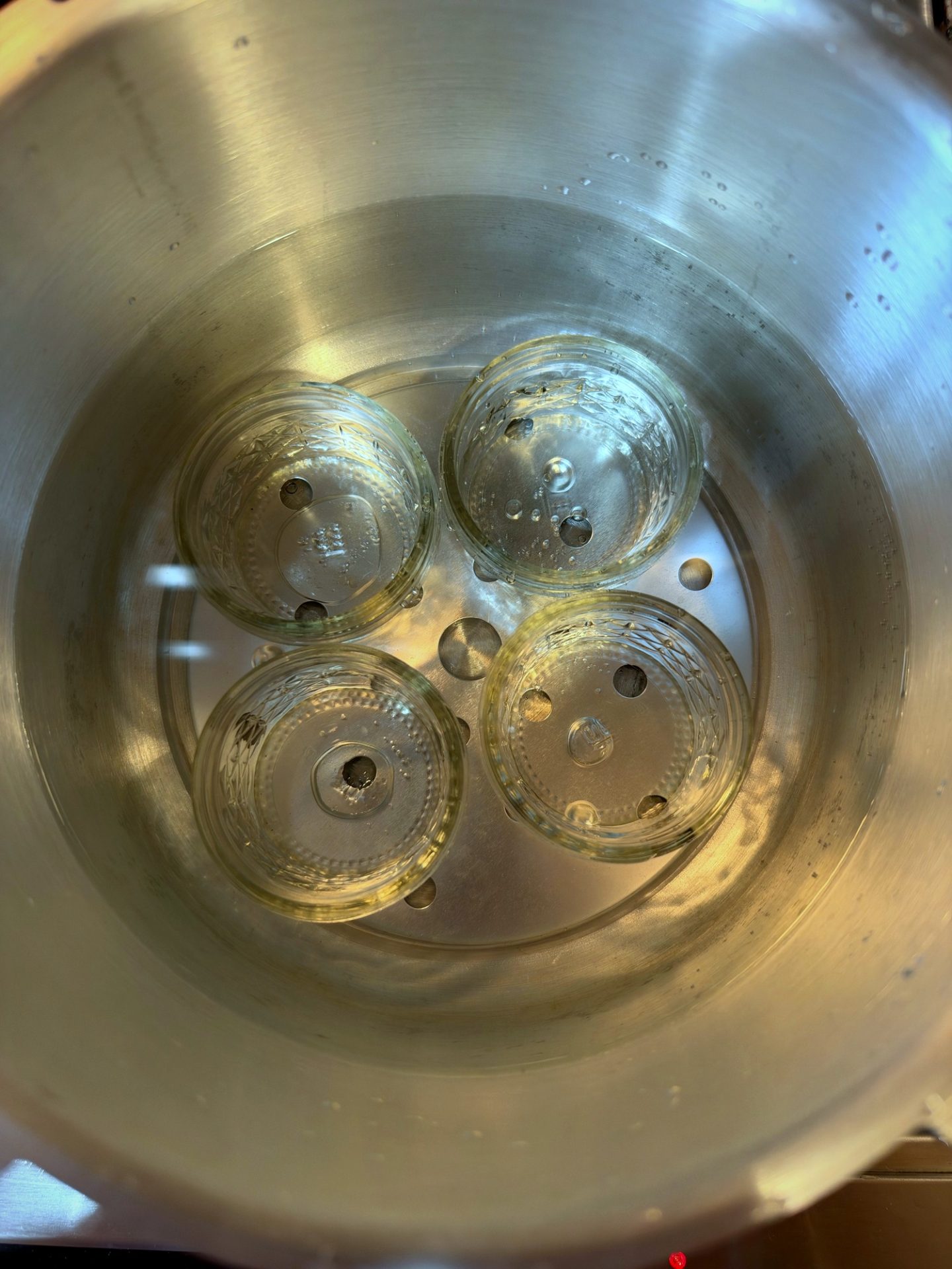 Half-pint jars sterilizing on the rack in the canner