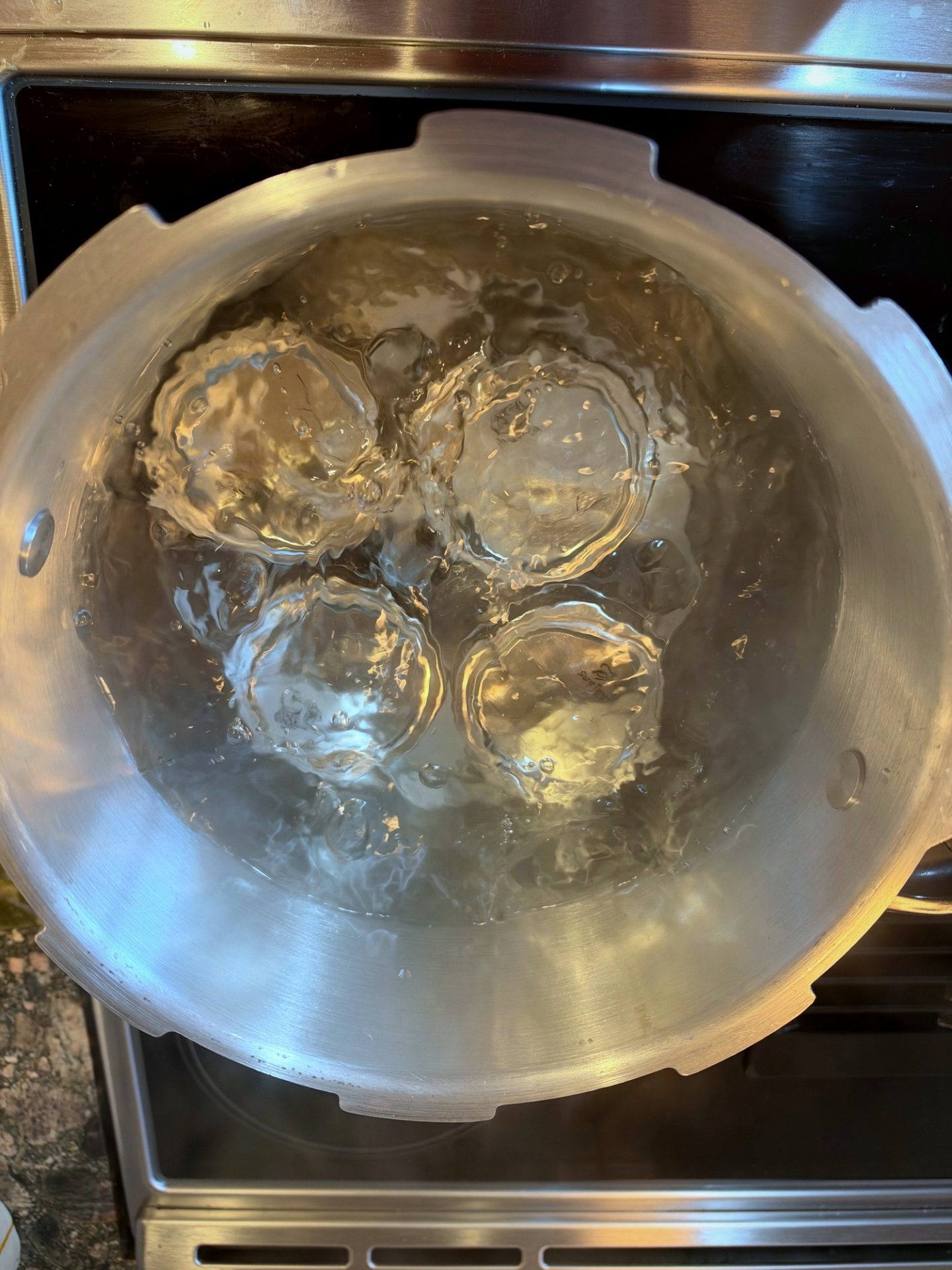 Filled jars of apple butter processing in the boiling-water canner