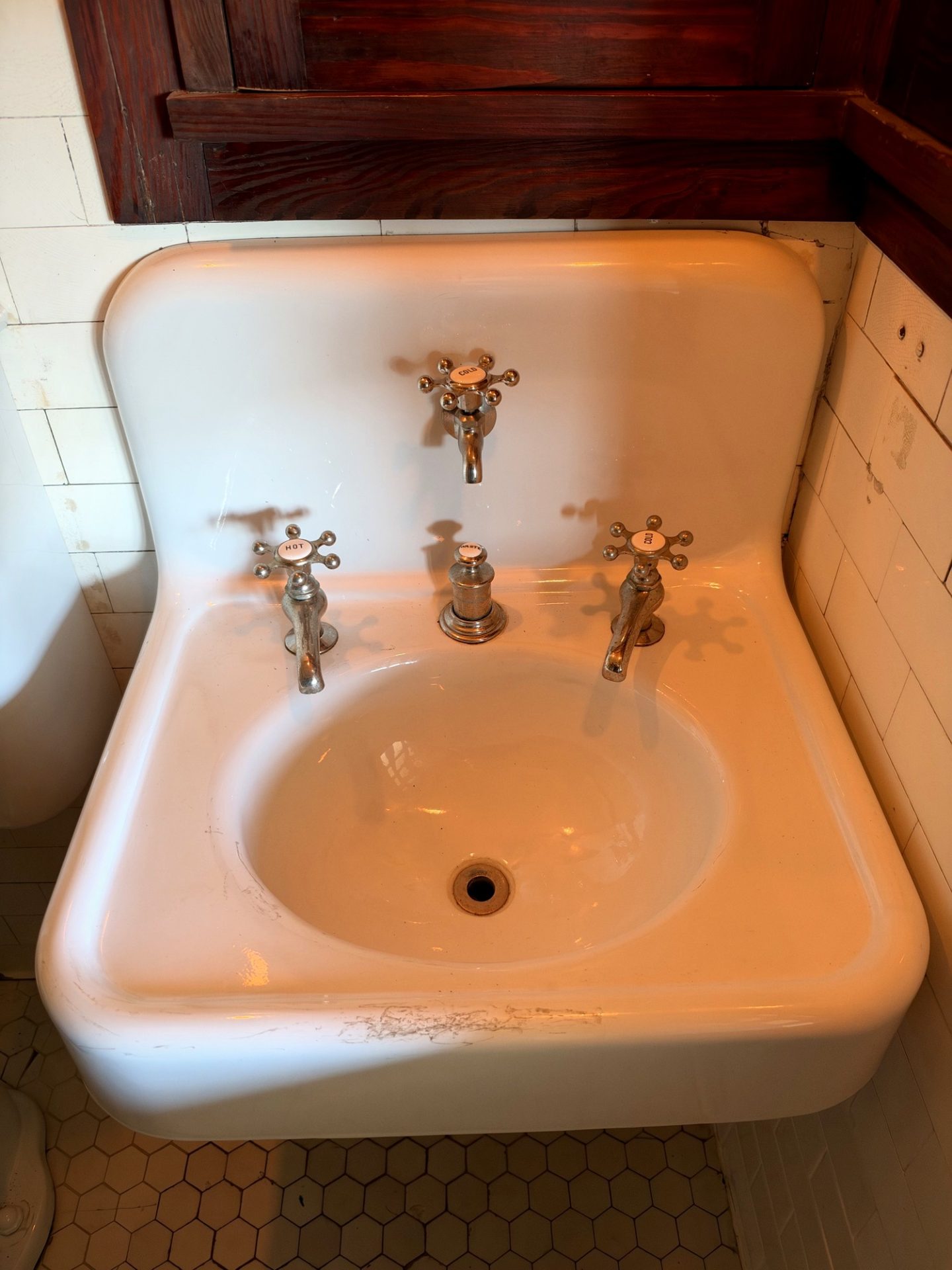 White porcelain bedroom sink with HOT WASTE COLD and rainwater drink faucet on subway tile at Westcott House