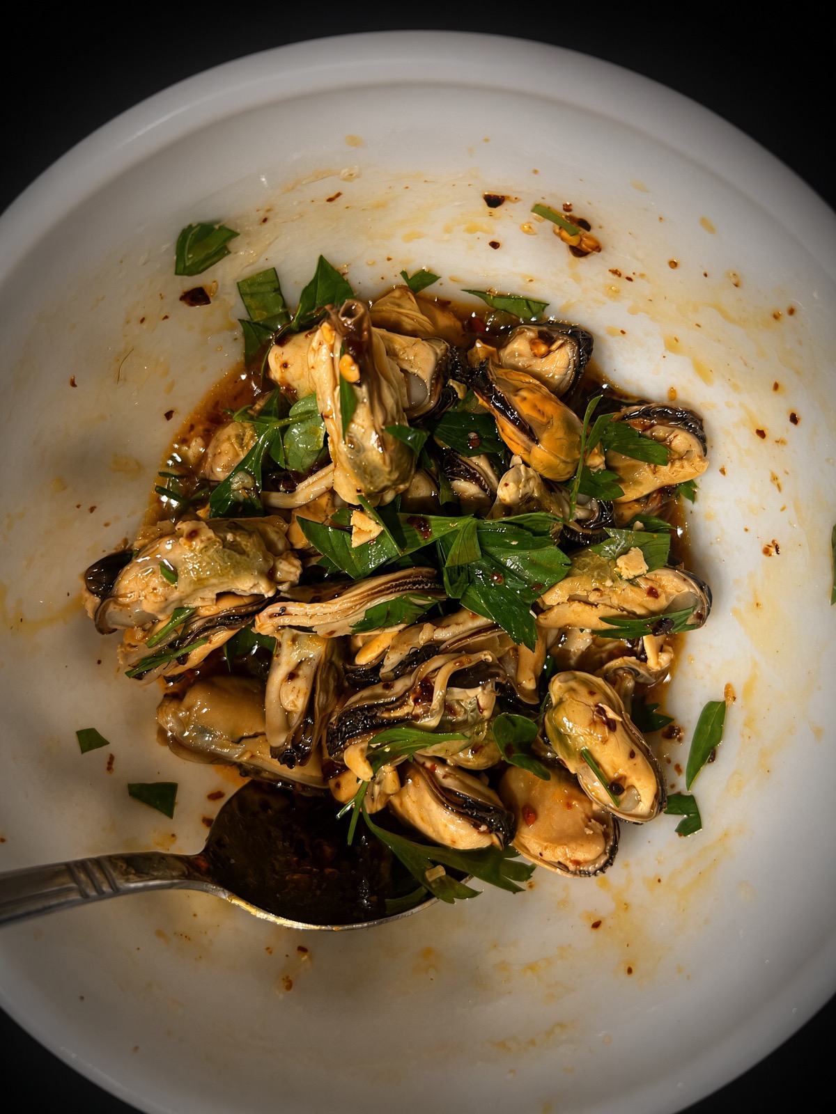 Smoked mussels tossed with chili crisp, parsley and Thai basil