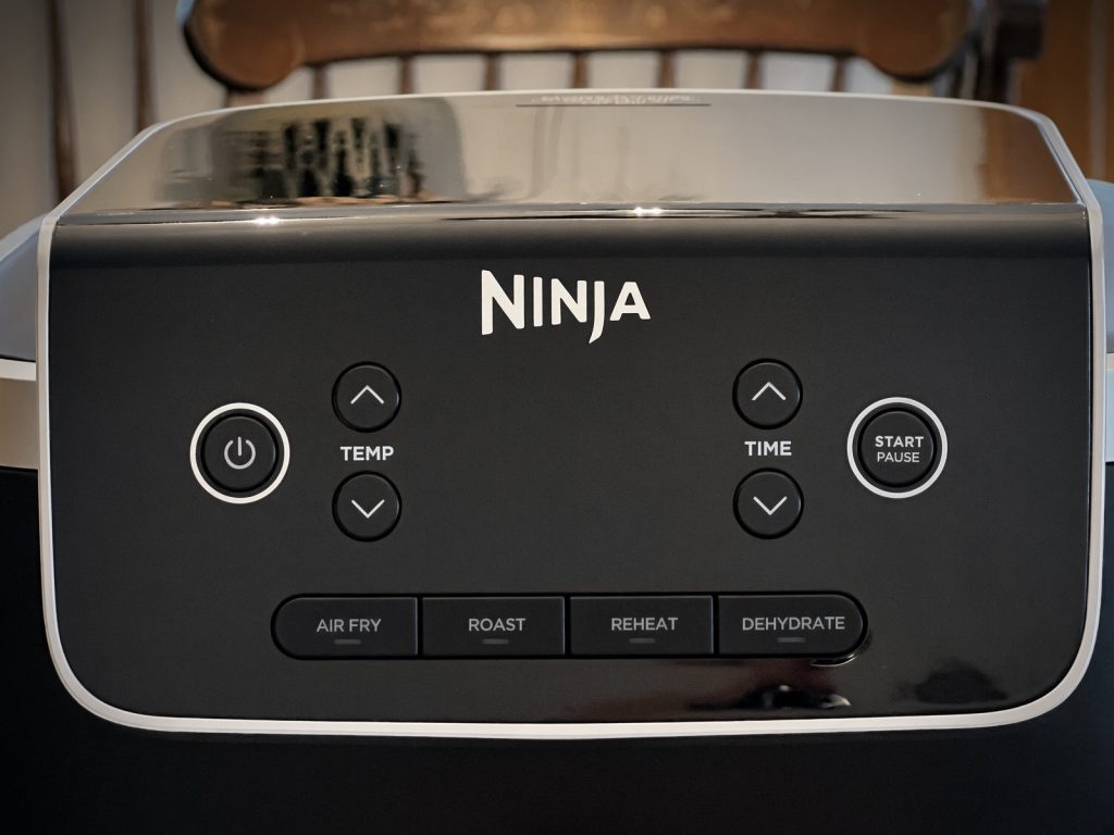 Close-up of the Ninja Air Fryer Pro control panel with Air Fry, Roast, Reheat and Dehydrate buttons