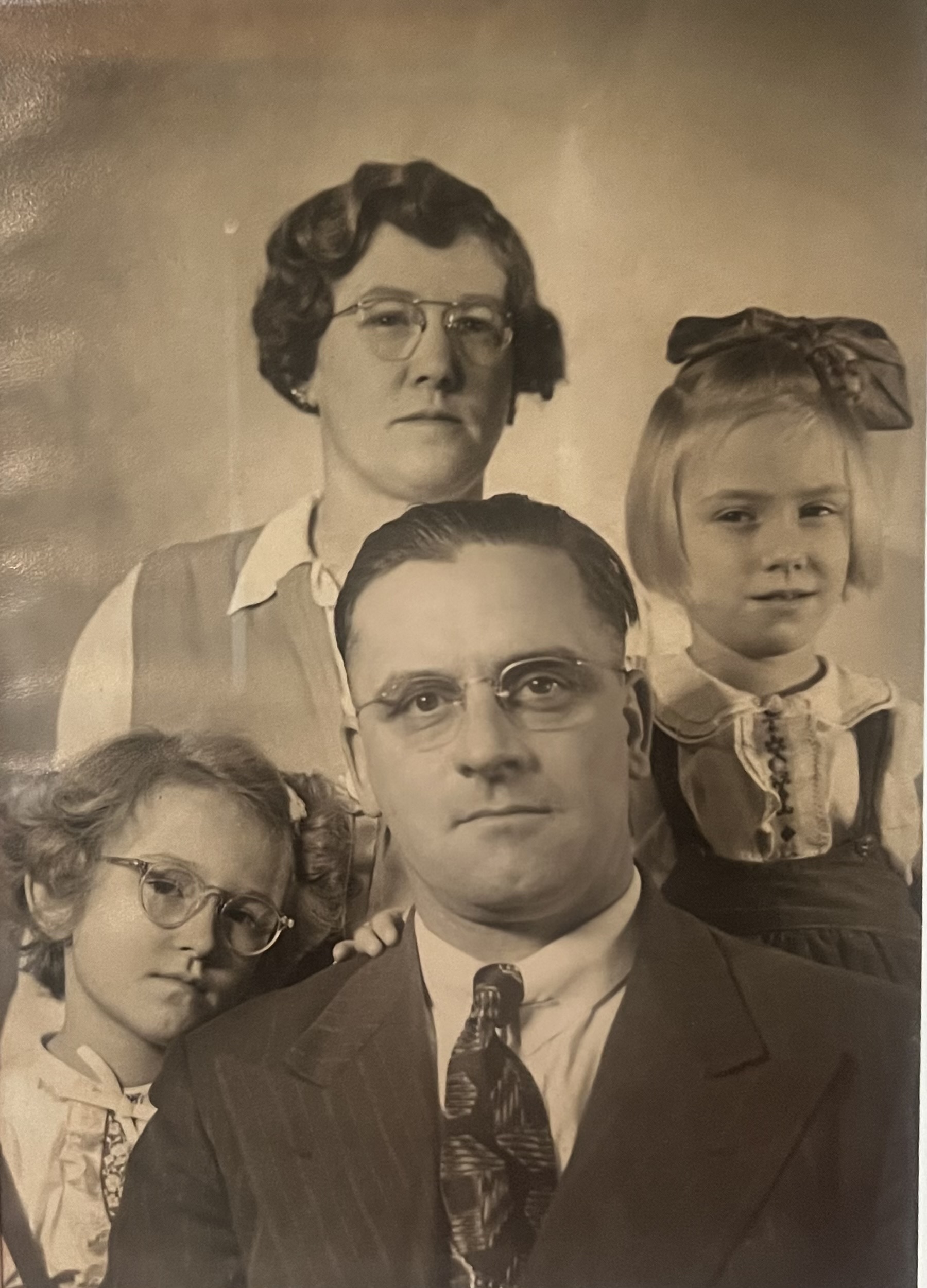 Vintage black-and-white family portrait of Grandpa Elwood and Grandma Alice Brandow with their two young daughters
