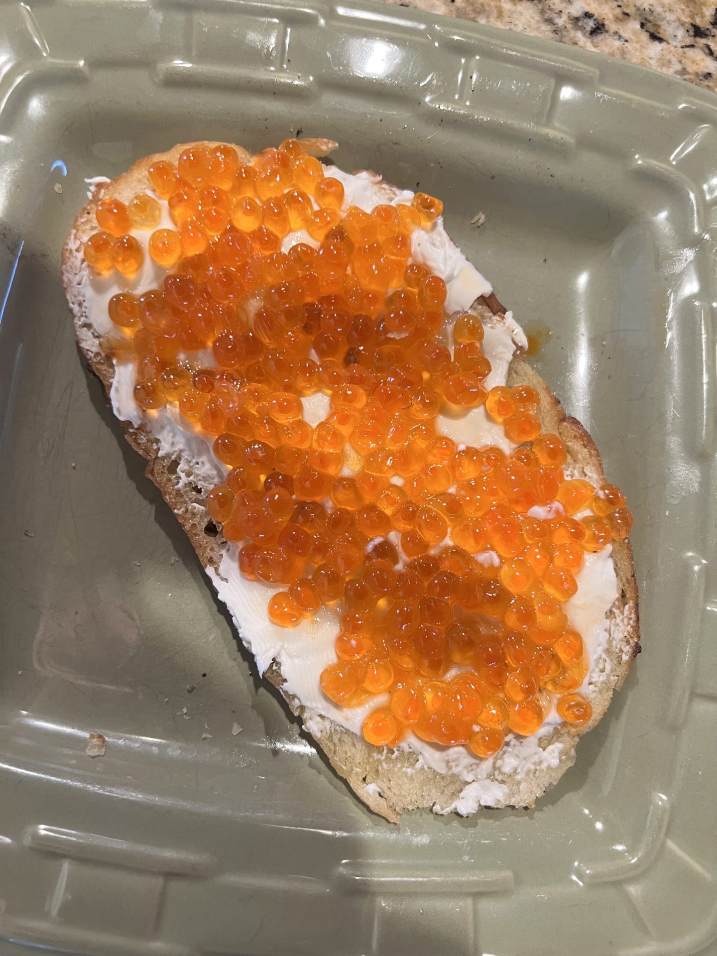 Toasted Italian bread topped with cream cheese and salmon roe