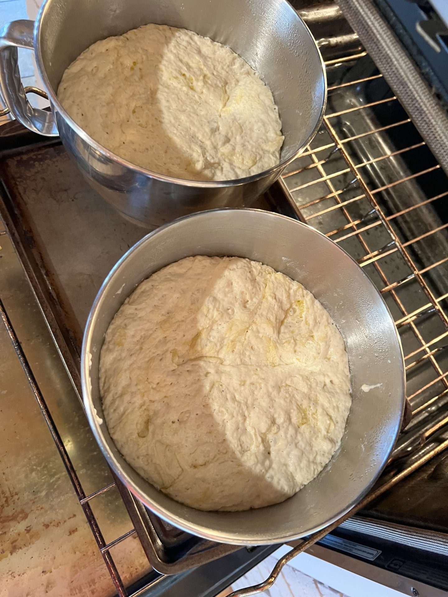 Two bowls of no-knead bread dough after the long rise