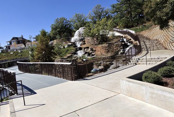 Curving walkway and railing below the stone waterfall at Finlay Park in Columbia, SC